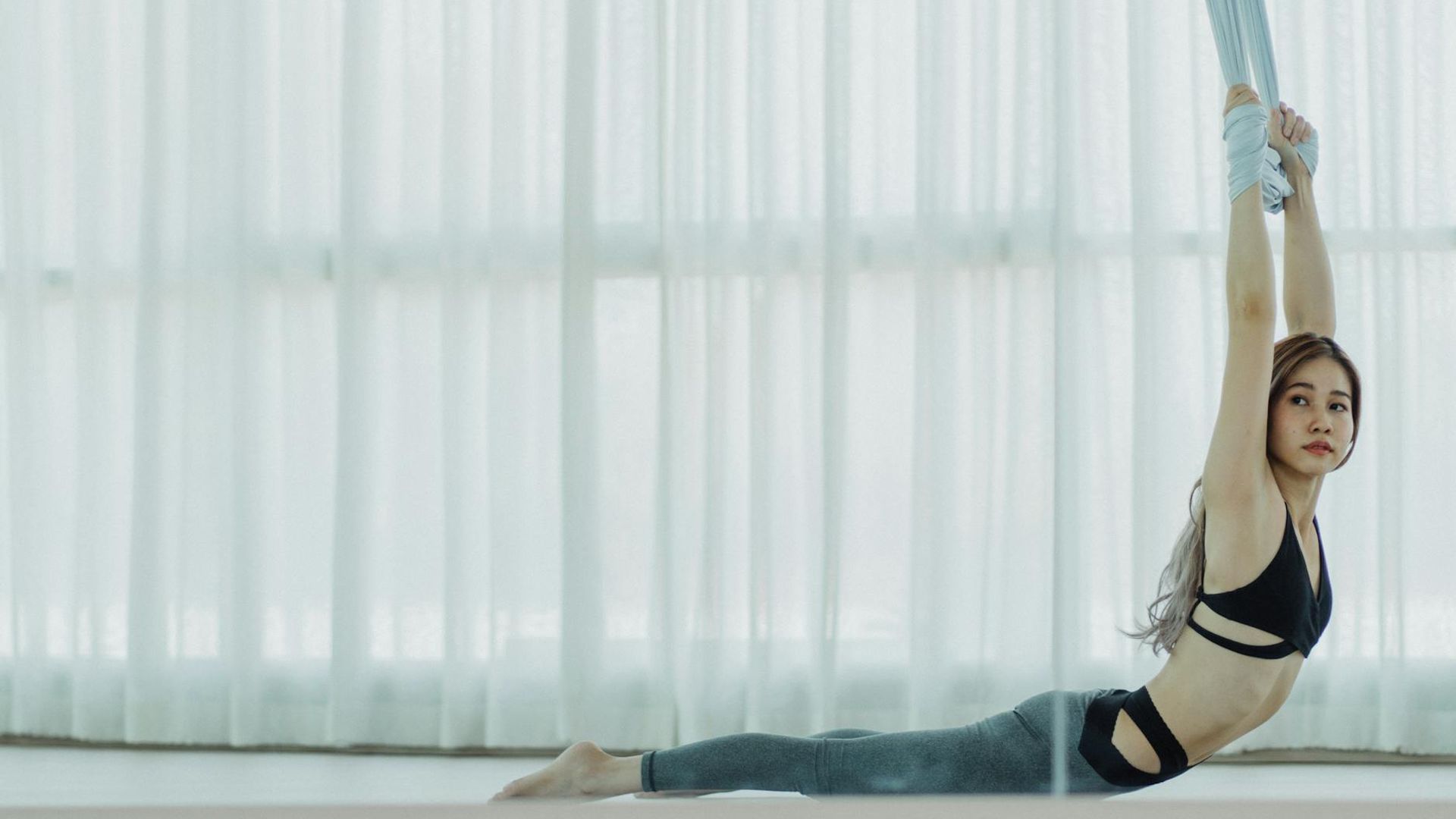 Serene dark yoga studio with soft golden light beams